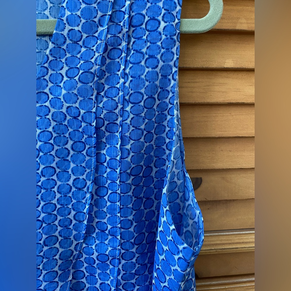 Chiffon sleeveless top with flattering layers of scalloped blue dots